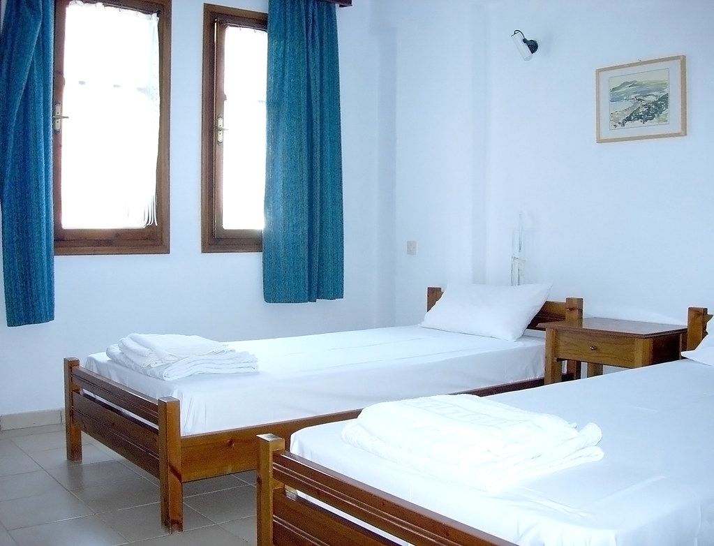 Twin room with blue curtains